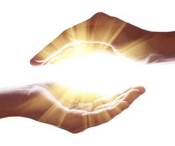 Woman hands protecting and containing bright, glowing, radiant, shining light. Emitting rays or beams expanding of center. Religion, divine, heavenly, celestial concept. White background copy space